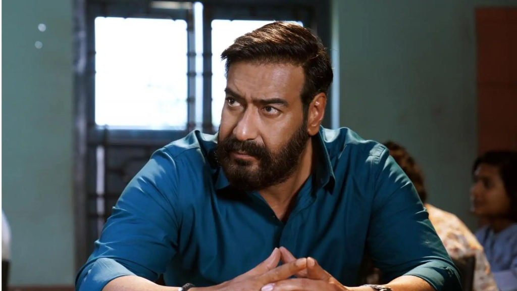 The image in the blog titled "Shooting of Drishyam 3 To Begin In October 2025" has Ajay Devgan sitting with an intense look on his face.